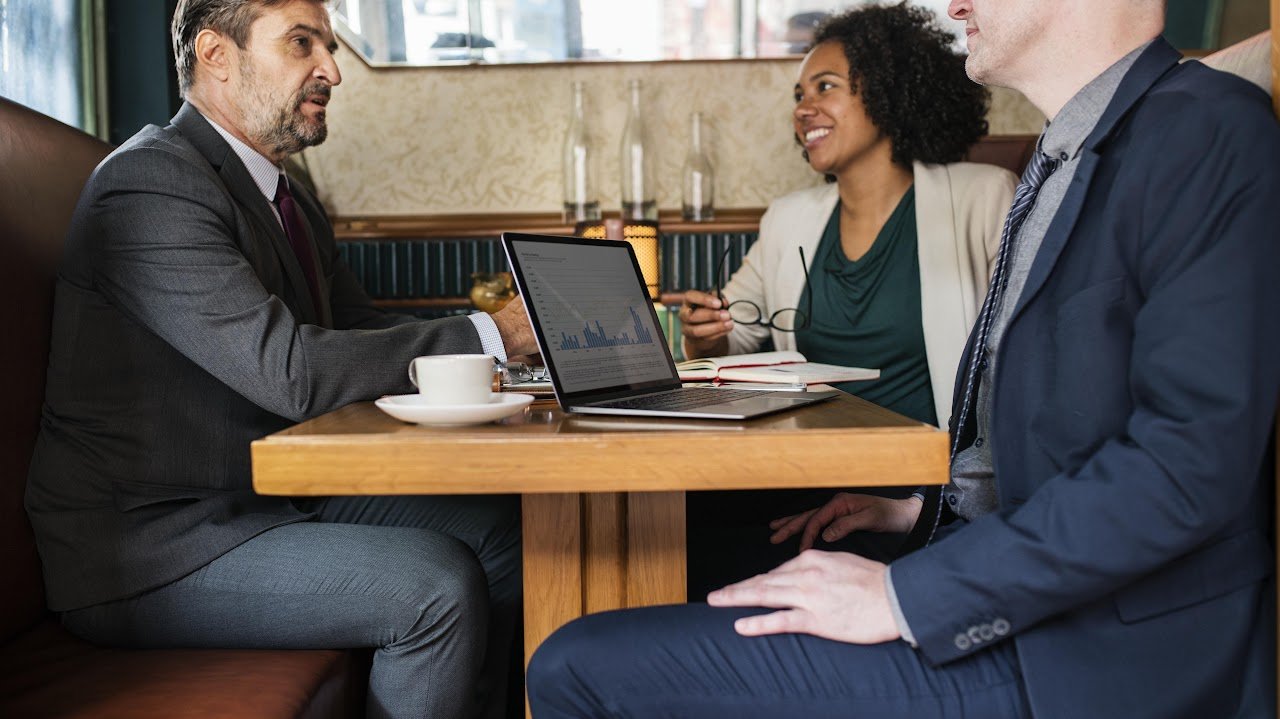 Professionals having a conversation around a table